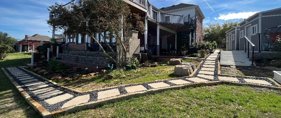 House in Little Elm, TX, with walkway along lawn and landscaping.