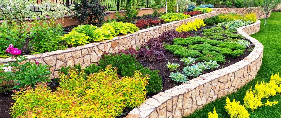 Retaining wall in Bartonville, TX, with raised planter bed.