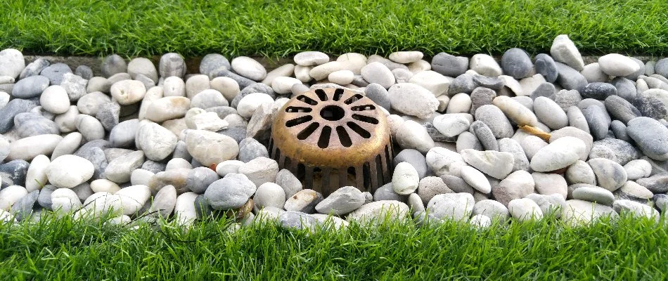 Rocks around the start of a French drain in Flower Mound, TX.